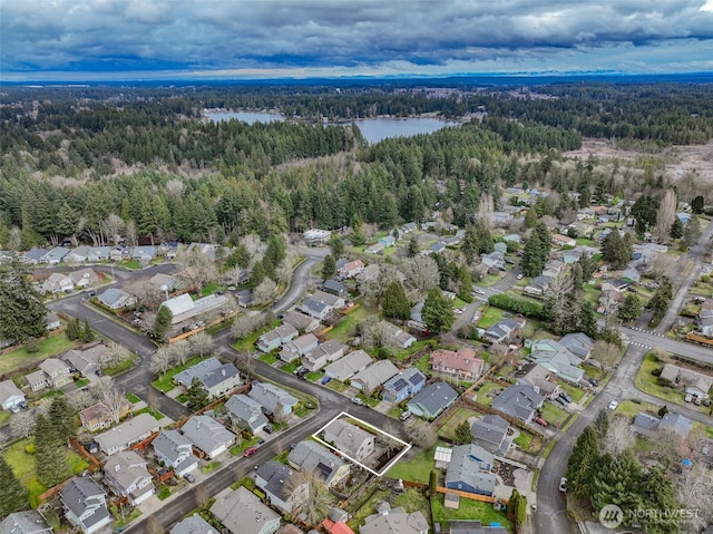 aerial view with a residential view, a forest view, and a water view