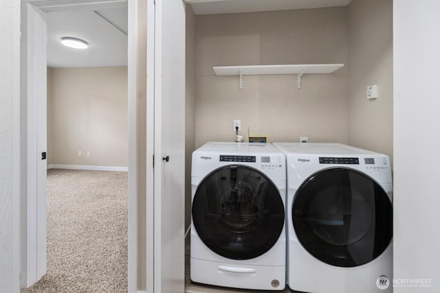 laundry room with baseboards, carpet, washing machine and dryer, and laundry area