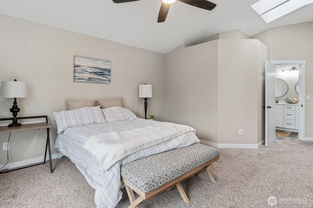 bedroom with vaulted ceiling with skylight, baseboards, carpet, and a ceiling fan