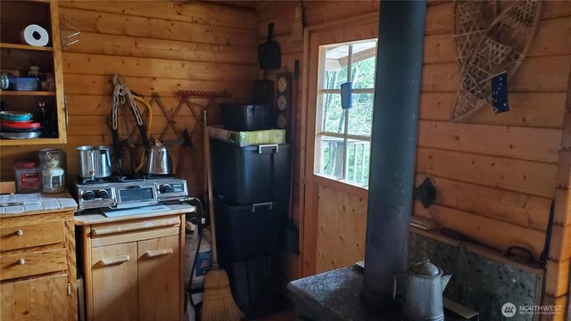 2001 N Dow Mountain Rd, Hoodsport, WA 98548 - kitchen with tile countertops, a wealth of natural light, and wood walls