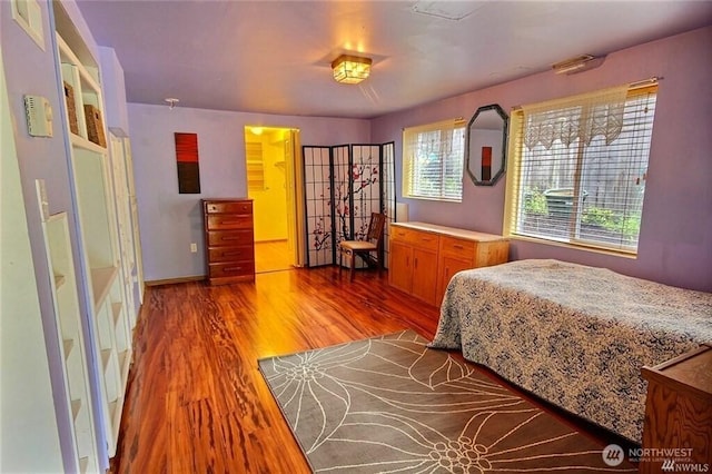 bedroom featuring baseboards and wood finished floors