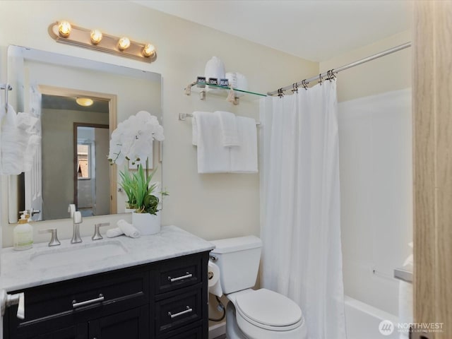 bathroom featuring vanity, toilet, and shower / bath combo with shower curtain