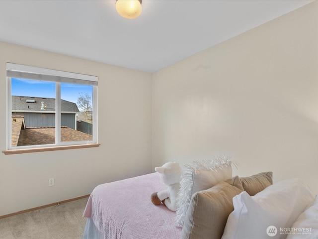 bedroom with baseboards and carpet