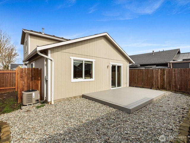 rear view of house featuring a patio, central AC, and fence