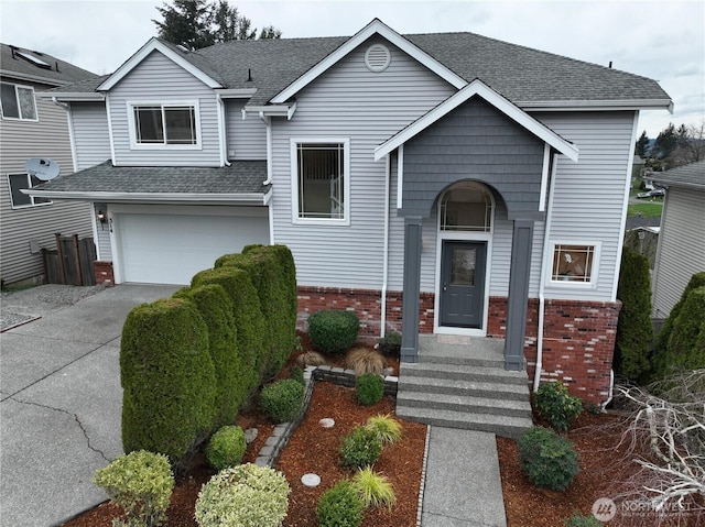 view of front of home featuring brick siding, driveway, a shingled roof, and a garage