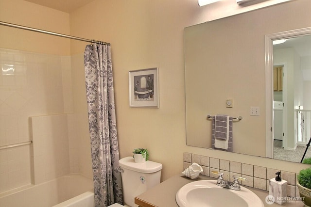 bathroom with toilet, vanity, and shower / bath combination with curtain