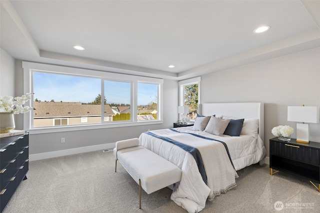 bedroom with light carpet, recessed lighting, multiple windows, and baseboards