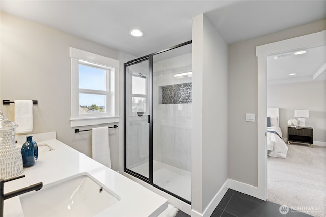 full bathroom featuring baseboards, recessed lighting, a sink, a shower stall, and ensuite bathroom