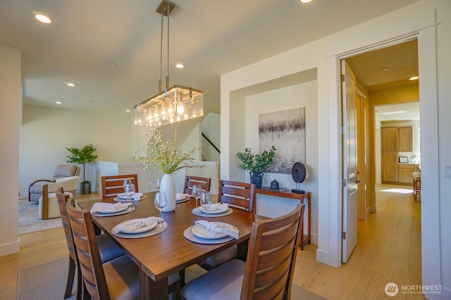 dining room featuring stairway, recessed lighting, baseboards, and light wood finished floors