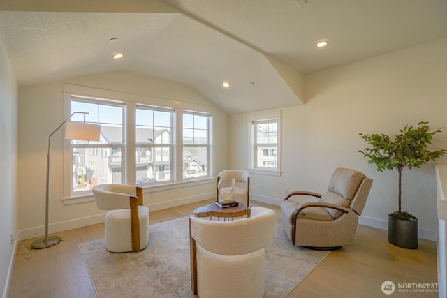 living area featuring recessed lighting, baseboards, light wood-style flooring, and vaulted ceiling