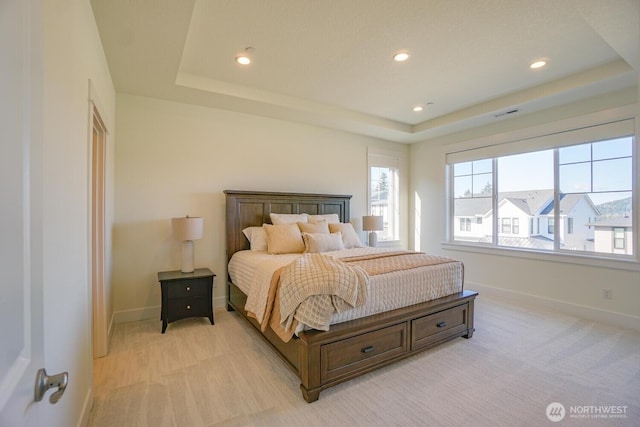 bedroom featuring recessed lighting, baseboards, and a raised ceiling