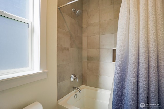 bathroom with toilet and shower / bath combo