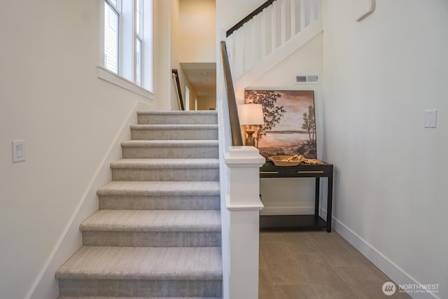 stairway featuring baseboards