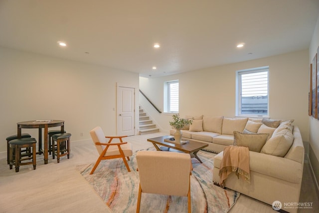 living room with light carpet, recessed lighting, stairs, and baseboards