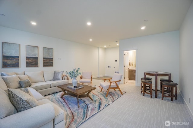 living area with recessed lighting, baseboards, and light carpet