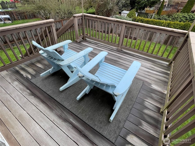 wooden deck featuring a lawn