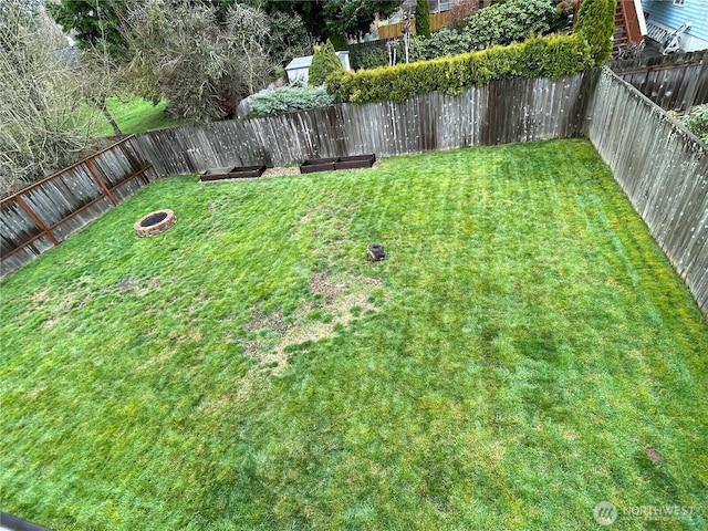 view of yard with a fenced backyard