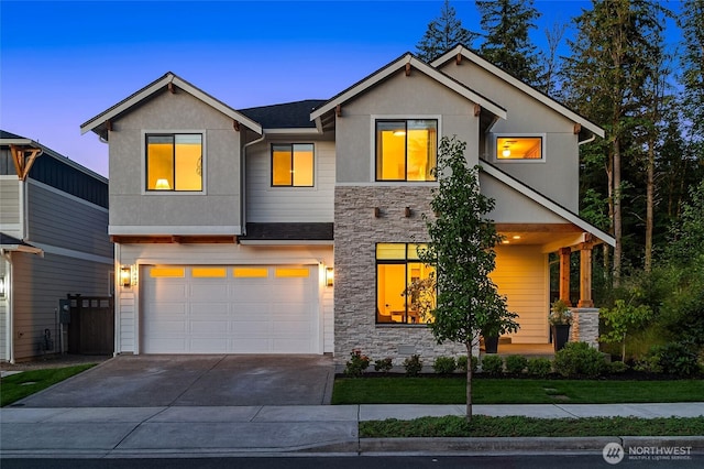 view of front of house featuring stone siding, stucco siding, driveway, and an attached garage