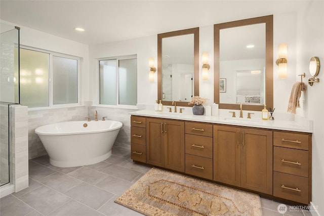 full bathroom featuring double vanity, tile patterned floors, and a sink