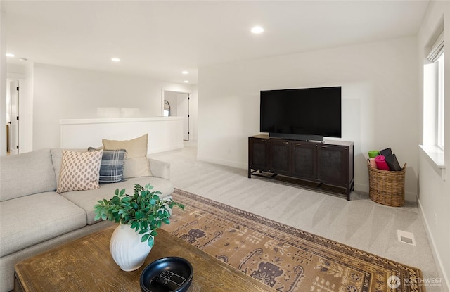 living area with recessed lighting, carpet, baseboards, and a healthy amount of sunlight