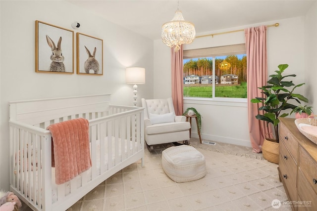 bedroom featuring a chandelier, visible vents, a nursery area, and baseboards