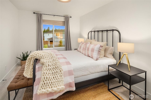 bedroom featuring carpet and baseboards