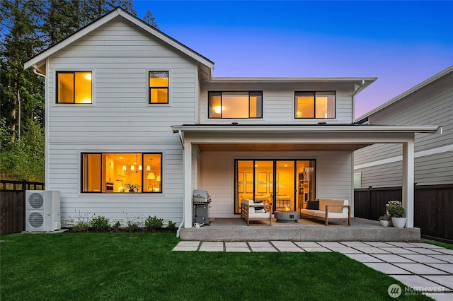 back of house featuring a patio area, an outdoor living space, a lawn, and fence