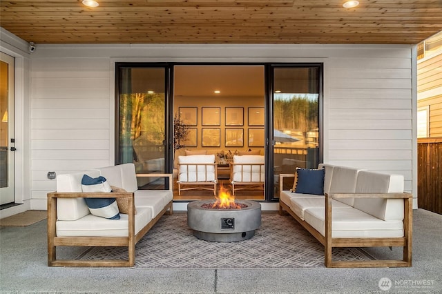 view of patio with an outdoor living space with a fire pit