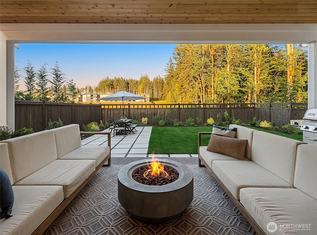 view of patio / terrace with an outdoor living space with a fire pit, outdoor dining area, and a fenced backyard