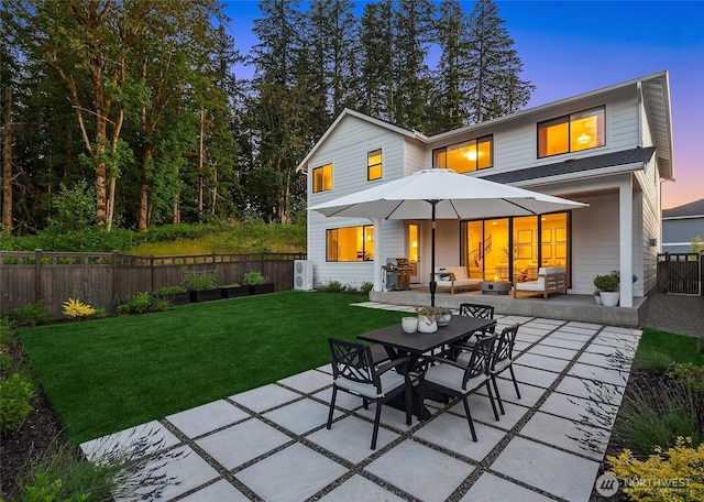 rear view of house with a yard, a patio, and fence