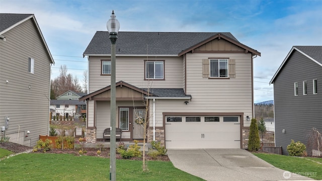 craftsman inspired home with stone siding, board and batten siding, concrete driveway, a front yard, and a shingled roof