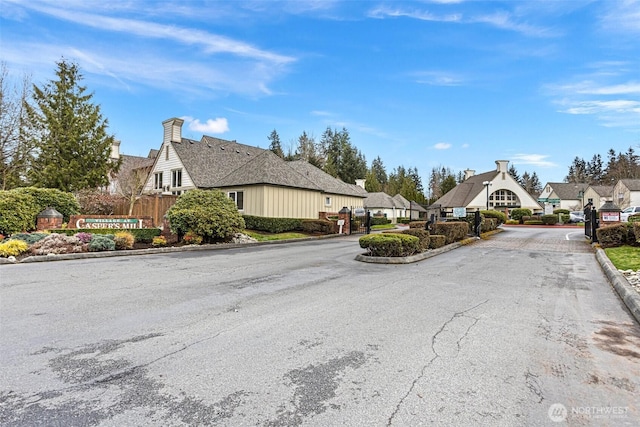 view of road featuring curbs and a gated entry