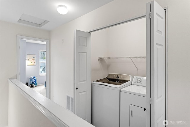 laundry room with washer and dryer, laundry area, attic access, and visible vents