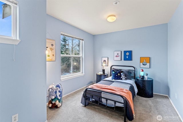 bedroom featuring baseboards and carpet