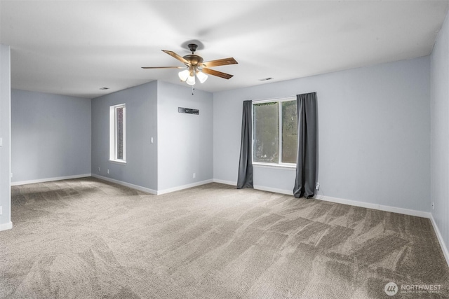 empty room featuring visible vents, a ceiling fan, baseboards, and carpet floors