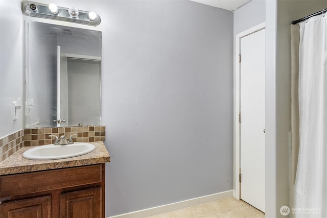 full bathroom featuring tile patterned floors, baseboards, tasteful backsplash, and vanity