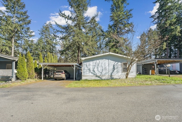 exterior space with a detached carport and driveway