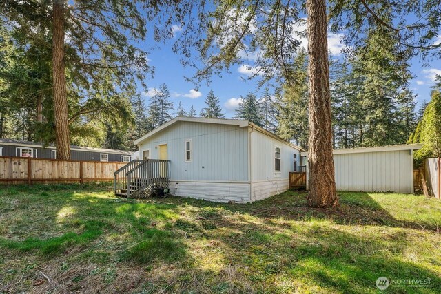 exterior space with a lawn and fence