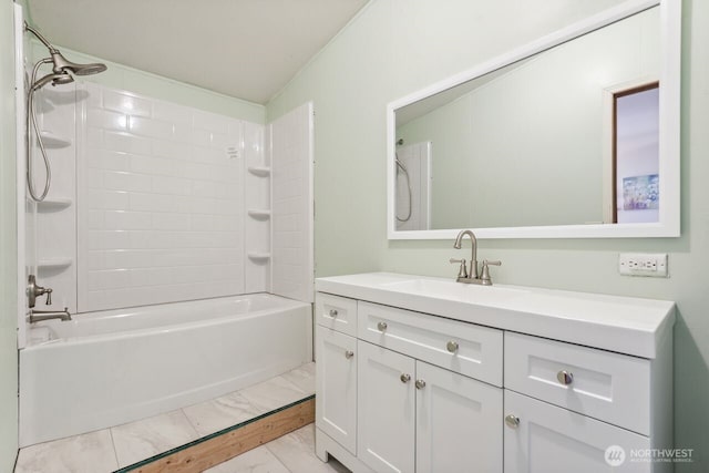 bathroom featuring marble finish floor, vanity, and  shower combination