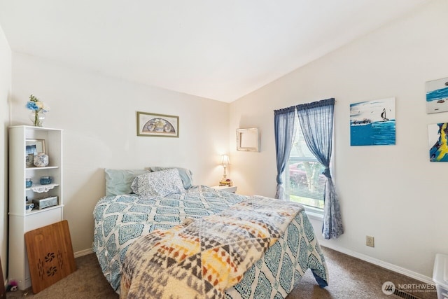 carpeted bedroom featuring baseboards and vaulted ceiling