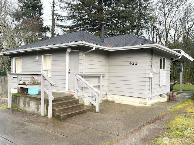 view of front of house with roof with shingles