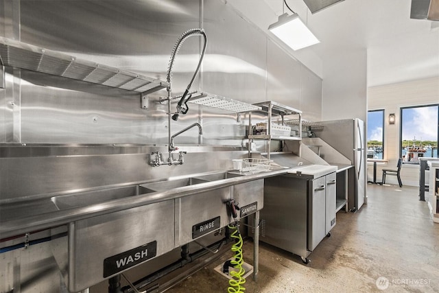 kitchen featuring stainless steel countertops and concrete floors