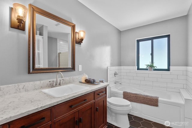 full bathroom featuring vanity, a garden tub, and toilet