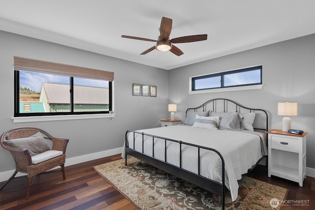 bedroom with a ceiling fan, baseboards, and dark wood-style flooring