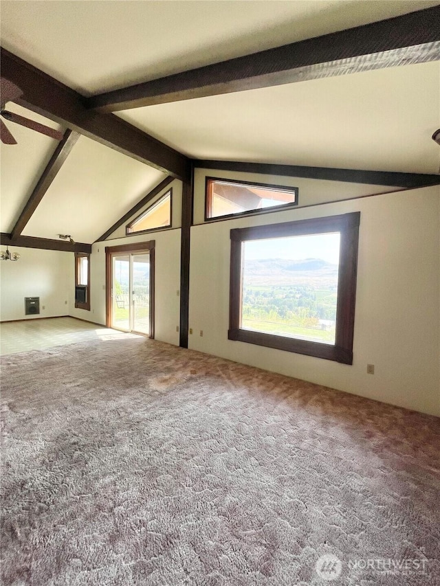 carpeted spare room with a ceiling fan and vaulted ceiling with beams