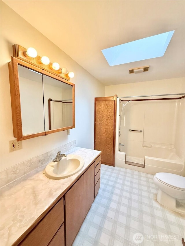 full bath with visible vents, washtub / shower combination, a skylight, tile patterned floors, and vanity