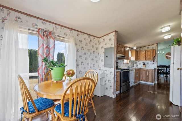 dining area with baseboards, dark wood finished floors, ornamental molding, and wallpapered walls