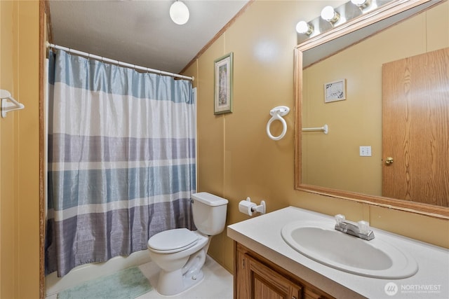 full bath with toilet, vanity, and ornamental molding