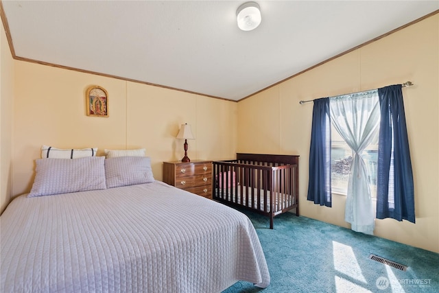 bedroom with vaulted ceiling, visible vents, carpet, and ornamental molding