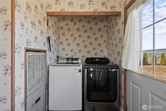 washroom featuring wallpapered walls, laundry area, and washer and clothes dryer